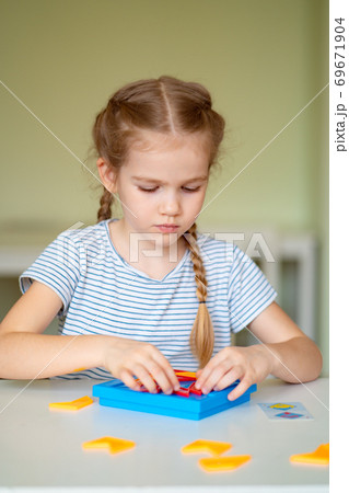 close up. little girl solve mathematical puzzle. close up. little girl solve mathematical puzzle. 69671904