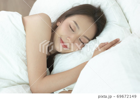 Asian women sleeping and sweet dream on white bed in bedroom 69672149