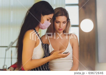 Young woman having professional eyebrow correction procedure in beauty salon. 69672646