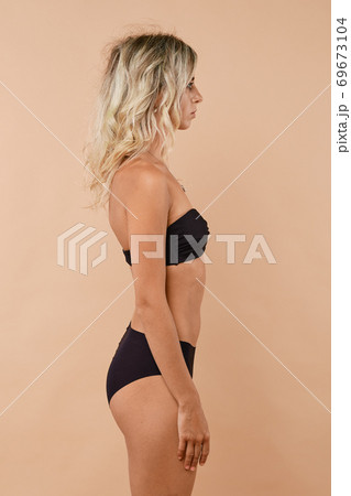 Portrait of young woman standing in profile Portrait of young woman standing in profile 69673104