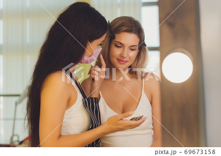 Young woman having professional eyebrow correction procedure in beauty salon. Young woman having professional eyebrow correction procedure in beauty salon. 69673158