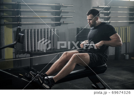 Sportsman Has Arms Workout On Rowing Machine . 69674326