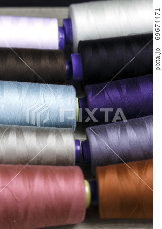 group of spools of thread of various colors 69674471