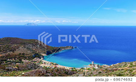 Beautiful seascape with beach and coastal town with a lighthouse in the bay. Giglio Island Beautiful seascape with beach and coastal town with a lighthouse in the bay. Giglio Island 69674692