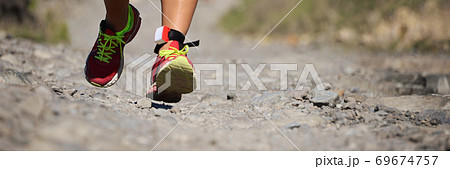 Trail running action close up of running shoes in action 69674757