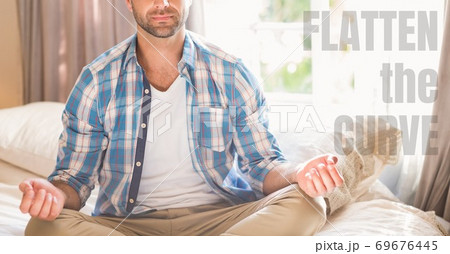 Caucasian man meditating with words Flatten the Curve during coronavirus covid19 pandemic Caucasian man meditating with words Flatten the Curve during coronavirus covid19 pandemic 69676445