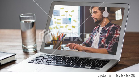 Man working and listening music on laptop screen 69676709