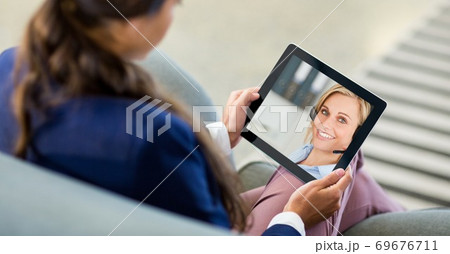 Woman having video call on digital tablet Woman having video call on digital tablet 69676711