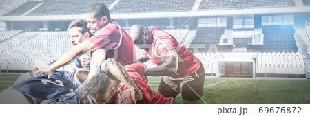 Digital composite image of team of rugby players playing rugby in sports stadium 69676872