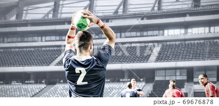Digital composite image of rugby player throwing the ball in sports stadium 69676878