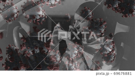 Caucasian man putting face mask on his car over coronavirus covid19 cells Caucasian man putting face mask on his car over coronavirus covid19 cells 69676881