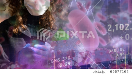Covid-19 cells and stock market data processing against woman wearing face mask using smartphone Covid-19 cells and stock market data processing against woman wearing face mask using smartphone 69677162