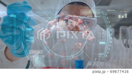 Scope scanning Covid-19 cells against scientist working in laboratory 69677416