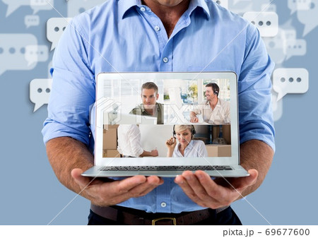 Mid section of man holding a laptop with screen showing video call self isolating at home d Mid section of man holding a laptop with screen showing video call self isolating at home d 69677600