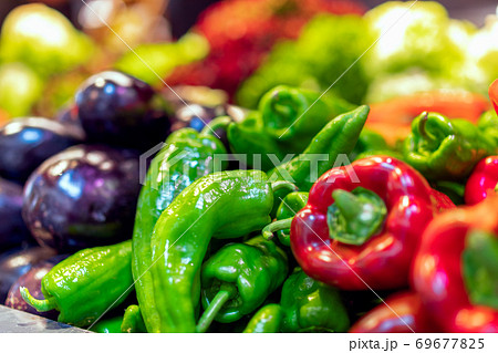 Fresh vegetables on the counter of the grocery market. Eggplant, paprika and pepper 69677825