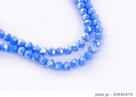 Beautiful blue Glass Sparkle Crystal Isoalted Beads on white background. 69680979