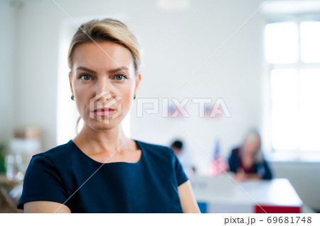 Portrait of serious woman in polling place, usa elections concept. Portrait of serious woman in polling place, usa elections concept. 69681748