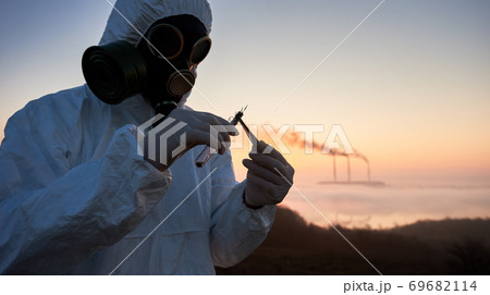 Scientist analyzing soil sample at thermal power station. 69682114