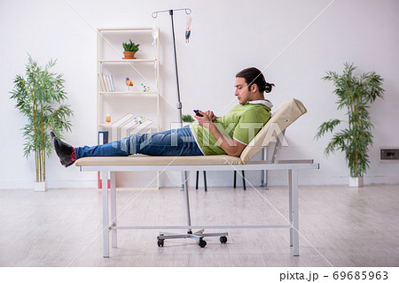 Young man waiting for doctor in the clinic Young man waiting for doctor in the clinic 69685963