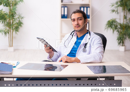 Young male doctor in telemedicine concept Young male doctor in telemedicine concept 69685965
