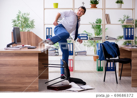 Young male employee businessman at workplace Young male employee businessman at workplace 69686372
