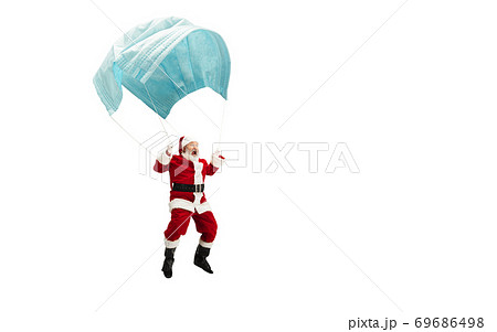 Santa Claus flying on huge face mask like on balloon isolated on white background Santa Claus flying on huge face mask like on balloon isolated on white background 69686498