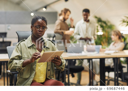 African-American Woman Posing with Tablet in Office African-American Woman Posing with Tablet in Office 69687446