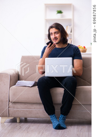 Young man employee working from house 69687856