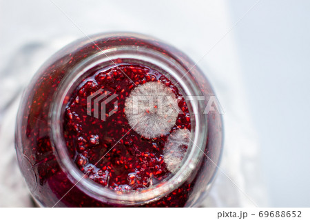 Mold in a jar of raspberry jam. Hazardous to health.  69688652