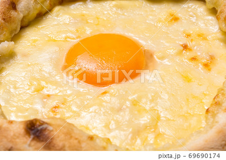 Adjarian Khachapuri closeup. Georgian national food. Focus on the yolk Adjarian Khachapuri closeup. Georgian national food. Focus on the yolk 69690174