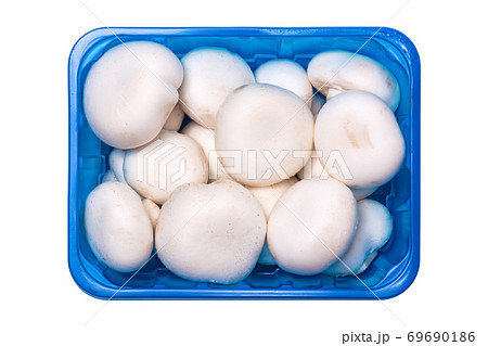 Fresh champignon mushrooms in a plastic container isolated on white Fresh champignon mushrooms in a plastic container isolated on white 69690186
