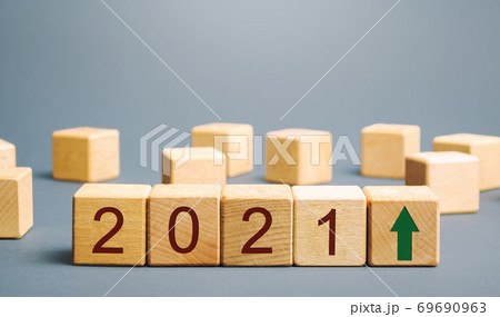 Wooden blocks with the inscription 2021 and an up arrow. The forecast concept for 2021. Business forecasting. Growth and development of business and economy. Vision. Targets and goals Wooden blocks with the inscription 2021 and an up arrow. The forecast concept for 2021. Business forecasting. Growth and development of business and economy. Vision. Targets and goals 69690963