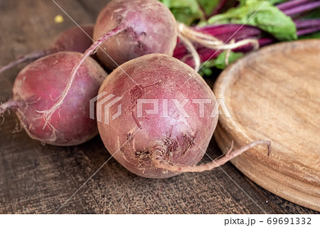 Whole red beets on a table 69691332