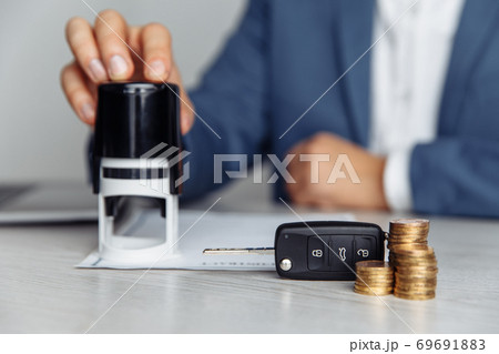 Car salesman stamping contract, concept for sale car, insurance with car, moving car or renting car Car salesman stamping contract, concept for sale car, insurance with car, moving car or renting car 69691883
