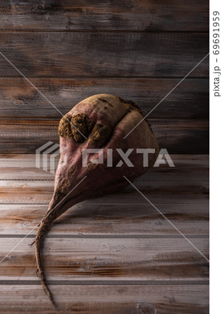 Big ugly organic ripe beetroot on a wooden background, close up Big ugly organic ripe beetroot on a wooden background, close up 69691959