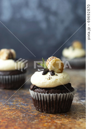 Chocolate cupcakes with butter cream. Sweet dessert, bakery, pastry dessert. 69692870