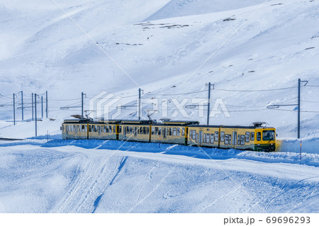 A Yellow swiss train in the railway from Interlaken to Jungfraujoch, Switzerland 69696293