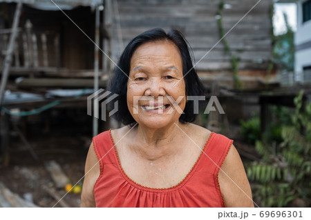 slow-motion of Thai elderly woman in round-necked sleeveless collar laughing in wooden home slow-motion of Thai elderly woman in round-necked sleeveless collar laughing in wooden home 69696301