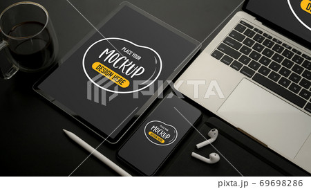 Mock up digital devices with tablet, smartphone, laptop and accessories on black desk 69698286