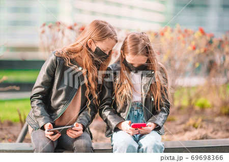 Girl wearing a mask protect against Coronavirus and gripp Girl wearing a mask protect against Coronavirus and gripp 69698366