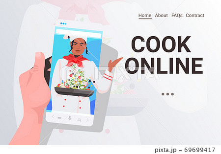 female chef on smartphone screen cooking salad during video call self isolation online communication 69699417