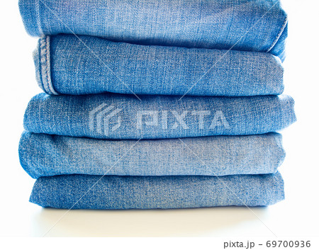 Pile of blue jeans, fabric texture 69700936
