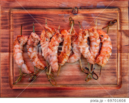 A professional cook prepares shrimps A professional cook prepares shrimps 69701608