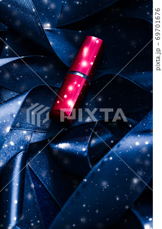 Red lipstick on blue silk and shiny glitter background, luxury make-up and beauty cosmetic Red lipstick on blue silk and shiny glitter background, luxury make-up and beauty cosmetic 69701676