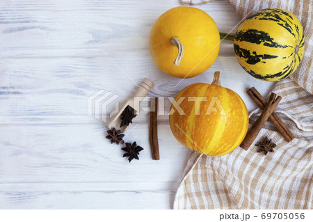 Autumn flatlay composition with pumpkin cinnamon and anise stars. Halloween concept. Flat lay, top view. Autumn flatlay composition with pumpkin cinnamon and anise stars. Halloween concept. Flat lay, top view. 69705056