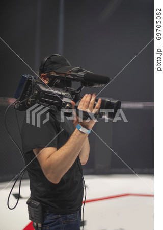 cameraman on the set of the ultimate fighting show. cameraman on the set of the ultimate fighting show. 69705082