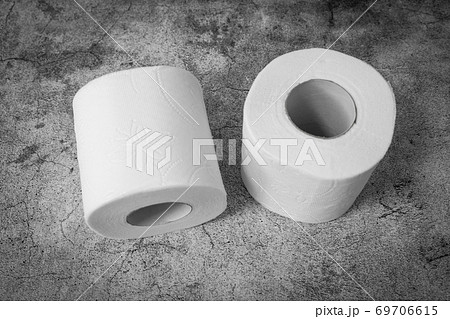 Top view of two rolls of toilet paper on gray texture background. Basic hygiene article shortage 69706615