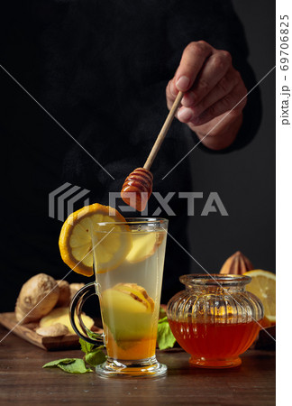 Ginger tea with lemon, mint and honey. Ginger tea with lemon, mint and honey. 69706825