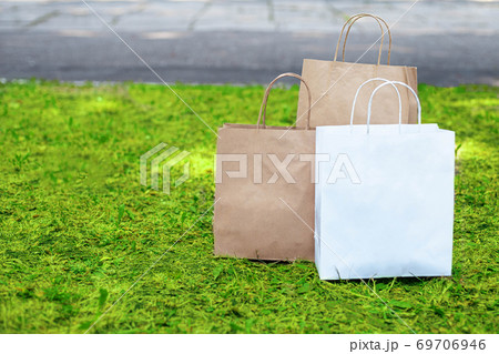 Say no to plastic bags. Paper bags on the grass Say no to plastic bags. Paper bags on the grass 69706946