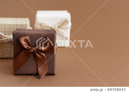Brown tones gift boxes on a brown background Brown tones gift boxes on a brown background 69708045